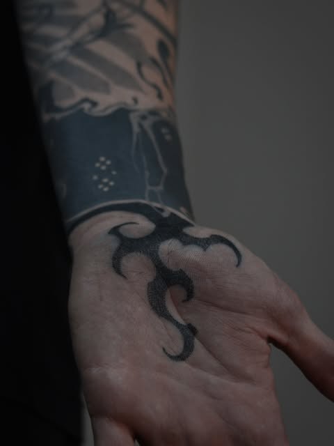 Blackwork hand and sleeve tattoo by Zuzana Mala
